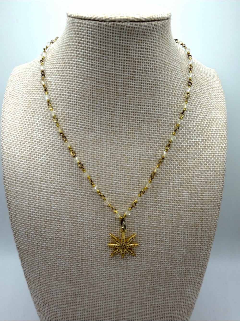 Golden Starburst Pendant on Gold and Clear Beaded Necklace Chain